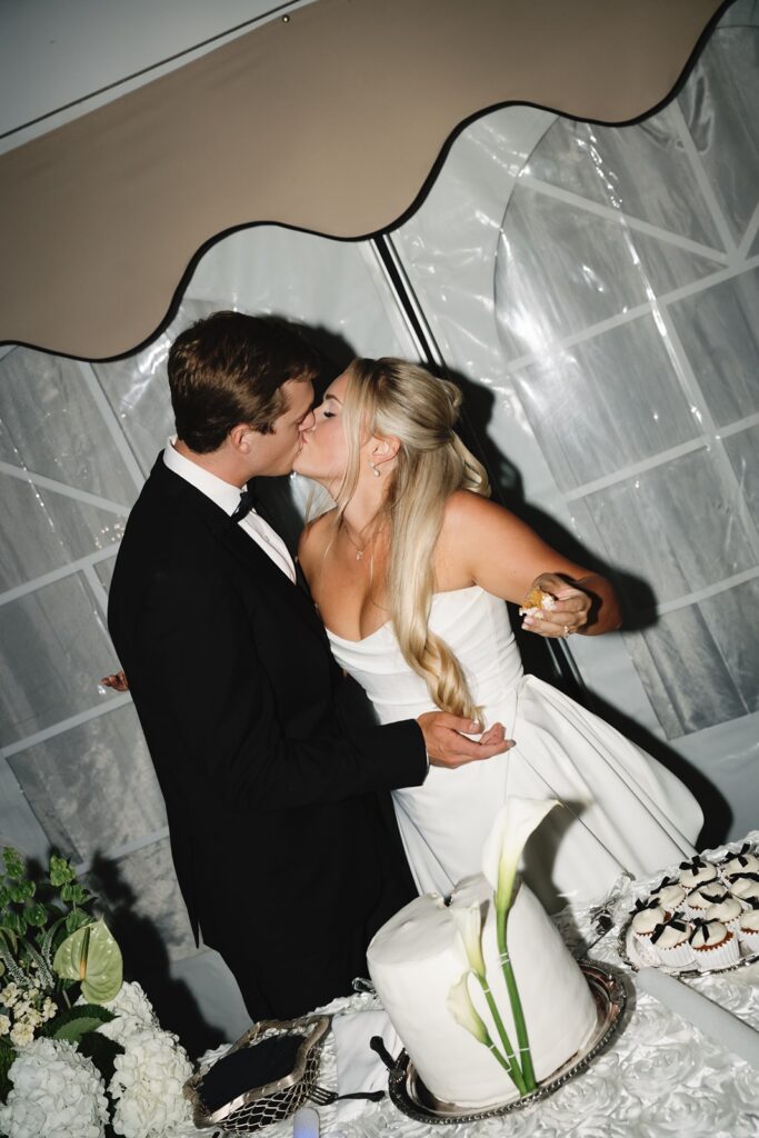 Bride and groom cut wedding cake at Grand Island Mansion
