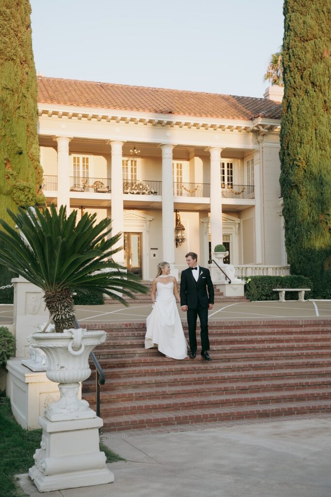 Bride and groom pose for sunset portraits at Grand Island Mansion