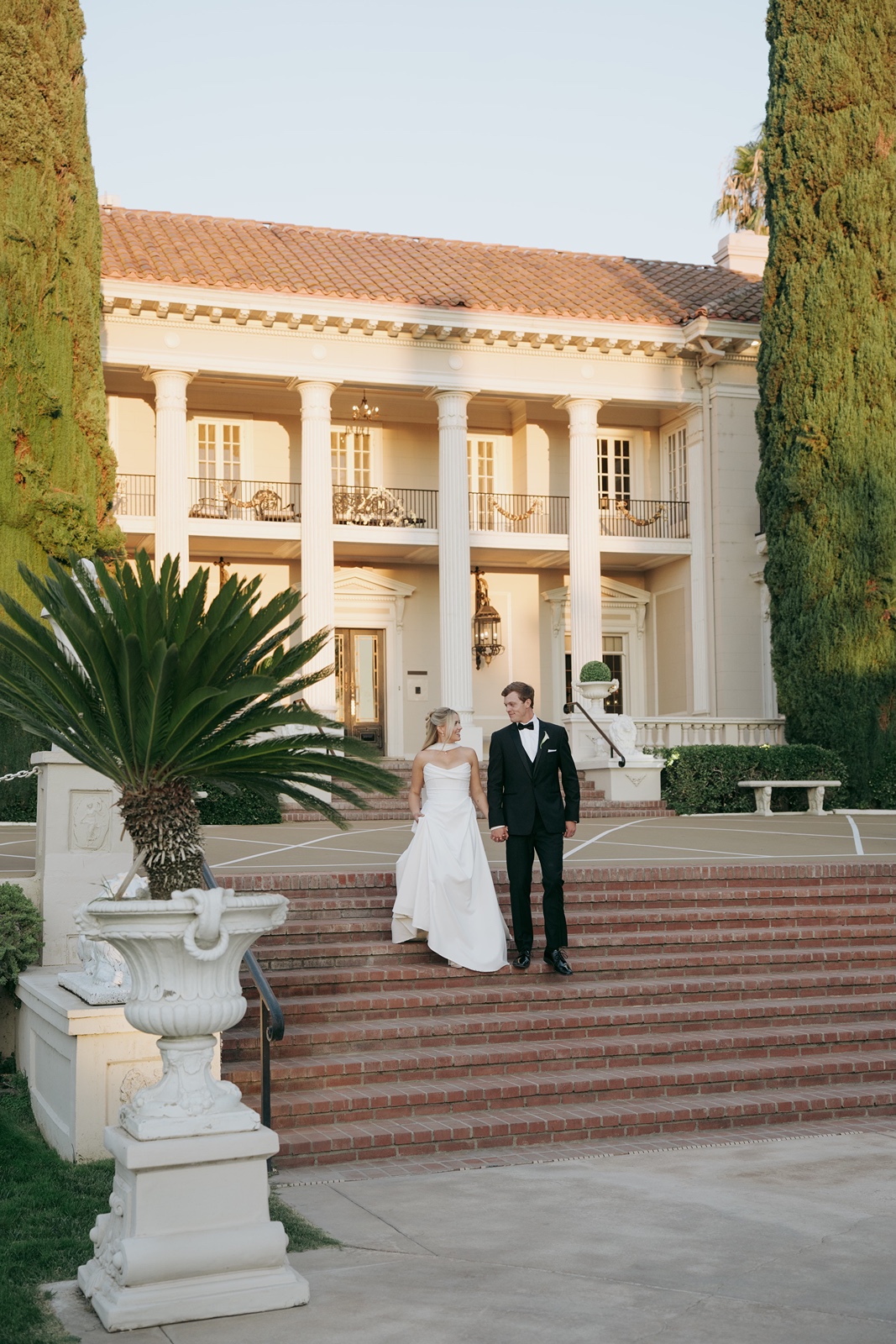 Bride and groom pose for sunset portraits at Grand Island Mansion