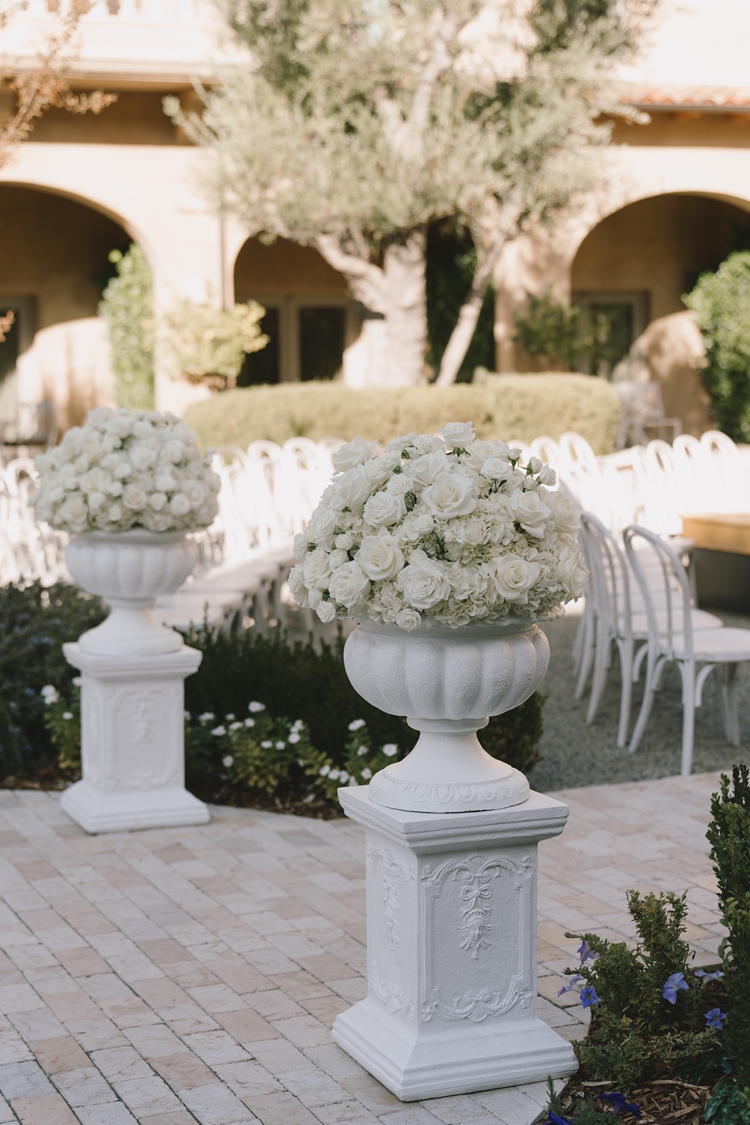 Large floral arrangements at the Allegretto Vineyard Resort wedding ceremony