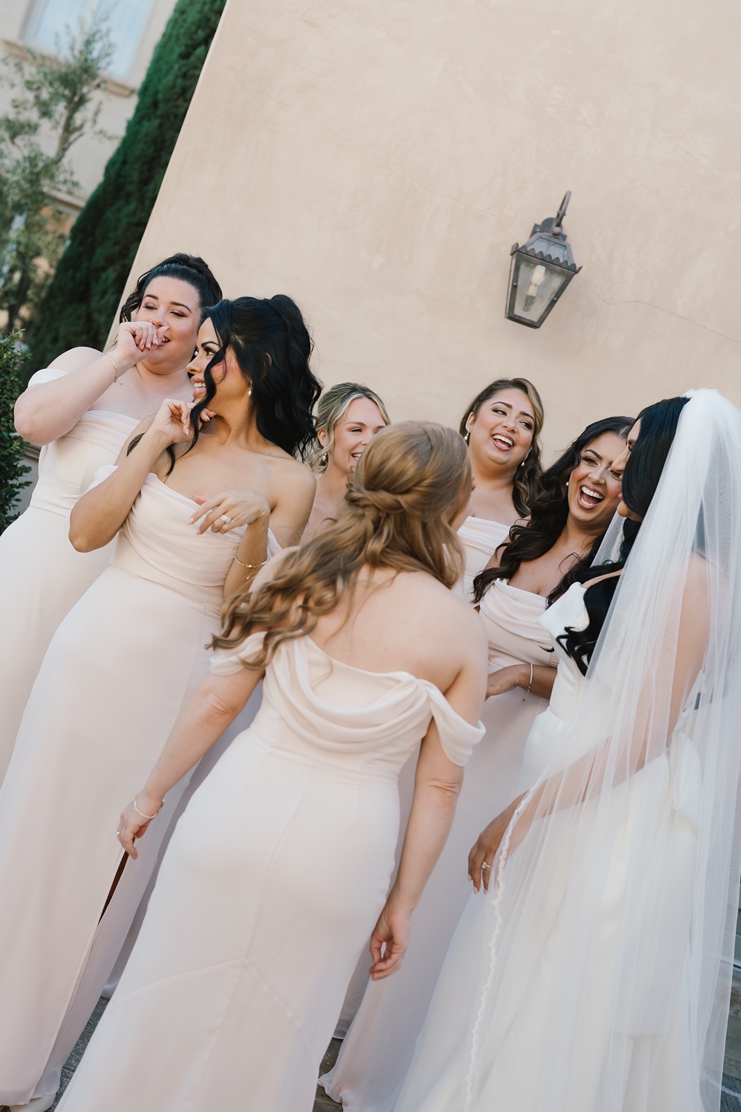 Bride and bridesmaids laugh during the Allegretto Vineyard Resort wedding
