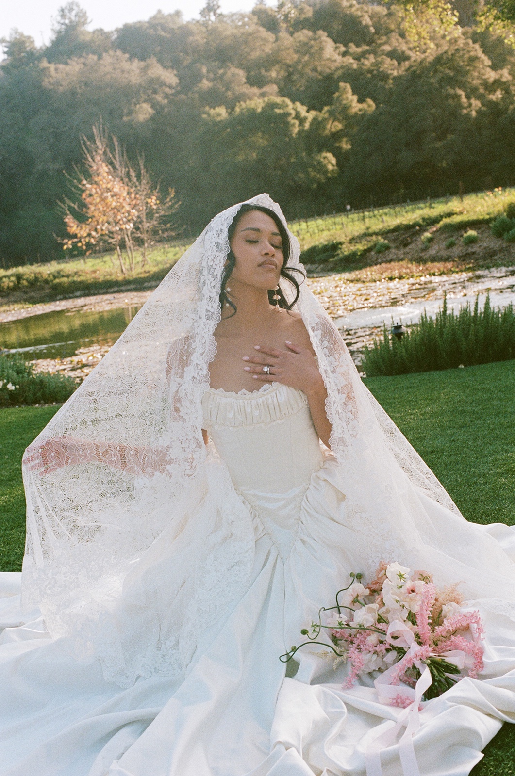 Bride sitting in the grass at her Monserate Winery wedding