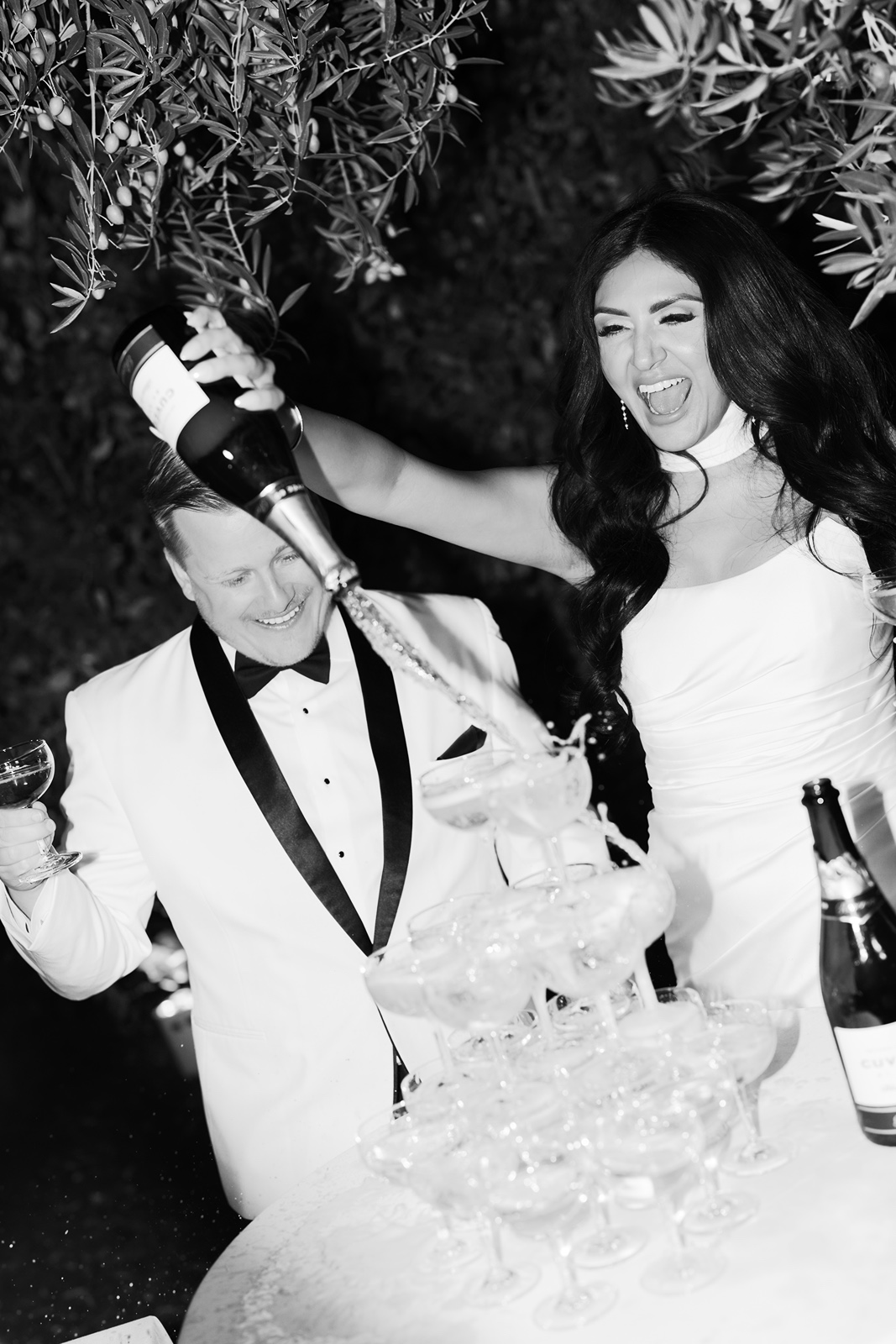Bride and groom pour champagne at their Allegretto Vineyard Resort wedding