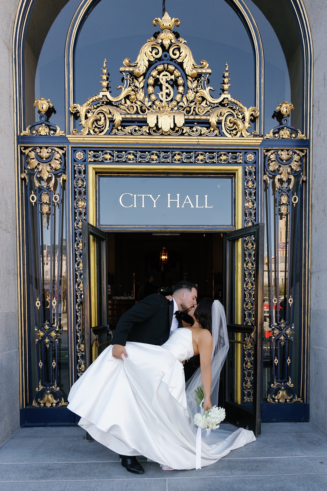 Bride and groom kiss outside of San Francisco City Hall wedding