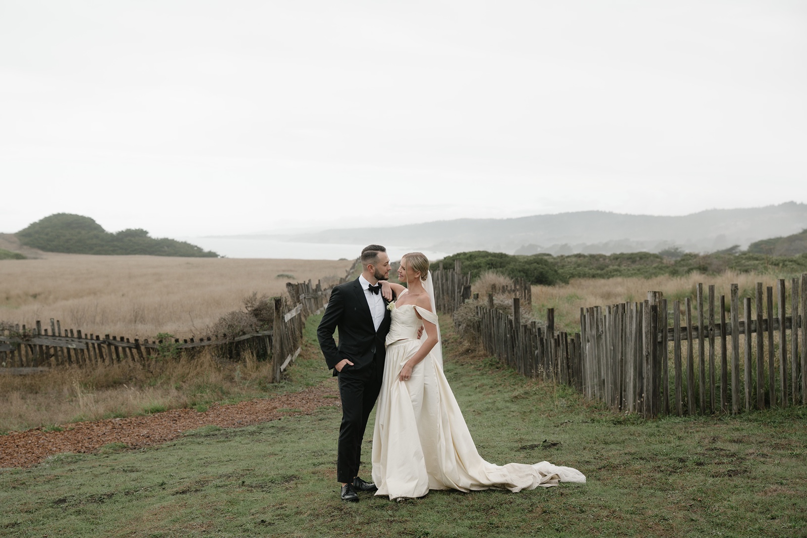 Bride and groom pose for wedding photos at Sea Ranch Lodge wedding