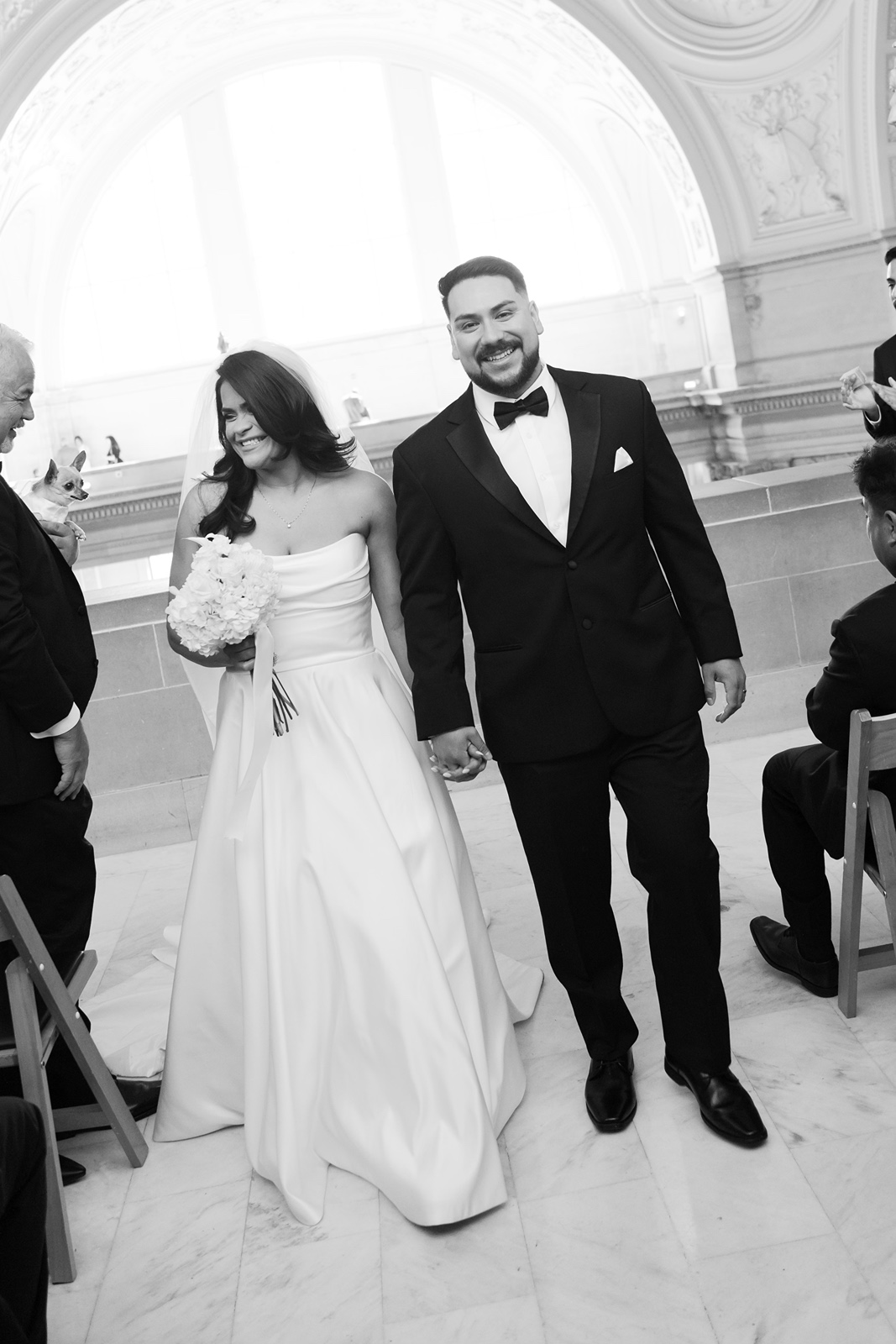 Bride and groom exit their wedding ceremony at San Francisco City Hall