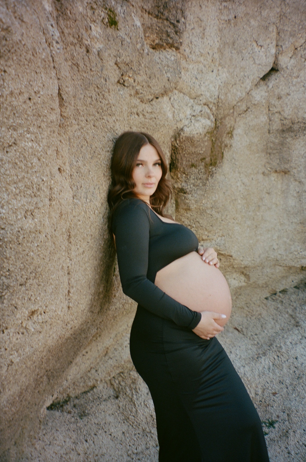 Woman smiles at camera during maternity photos in Sacramento