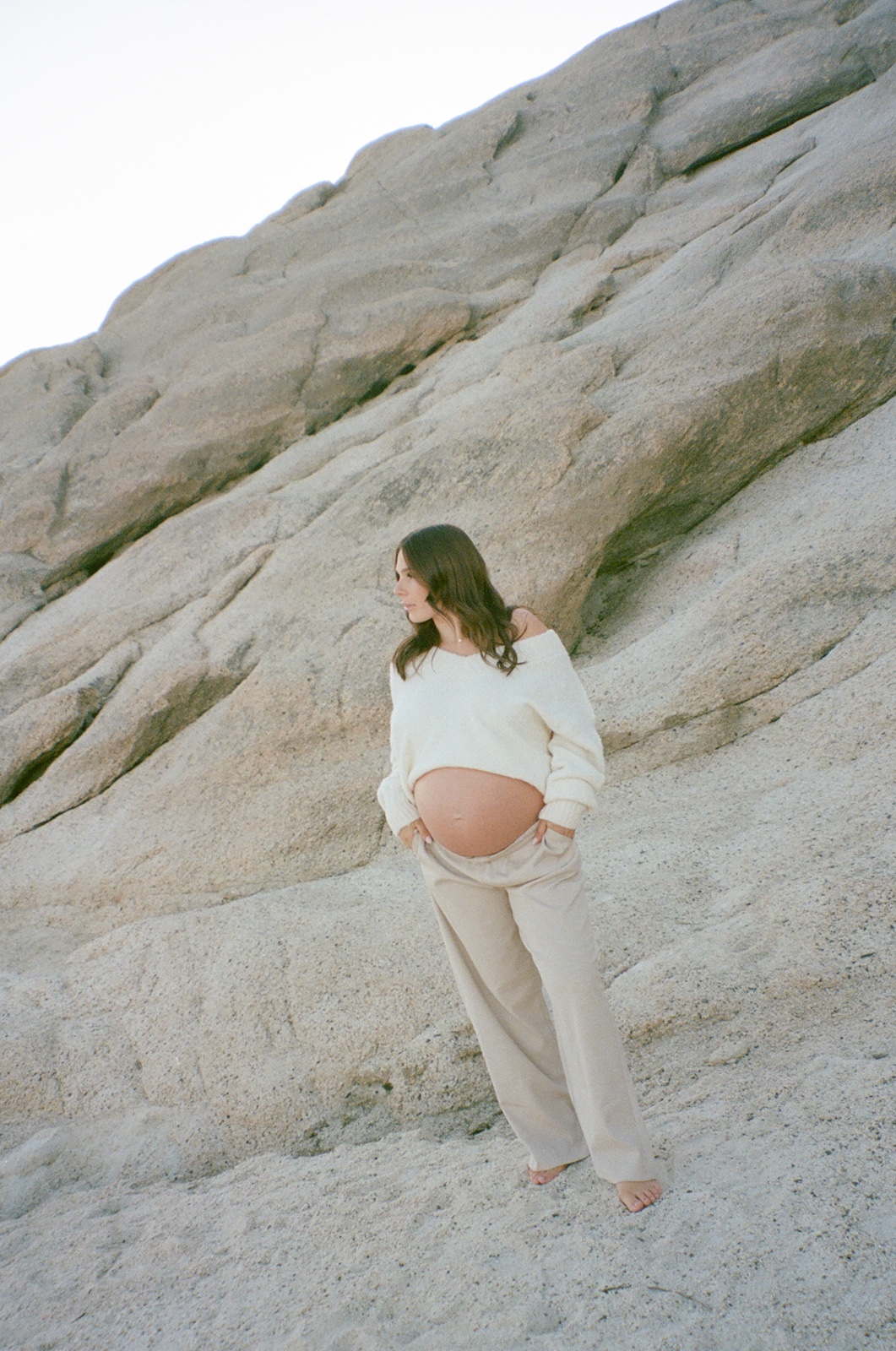 Woman in white sweater at maternity photos in Sacramento
