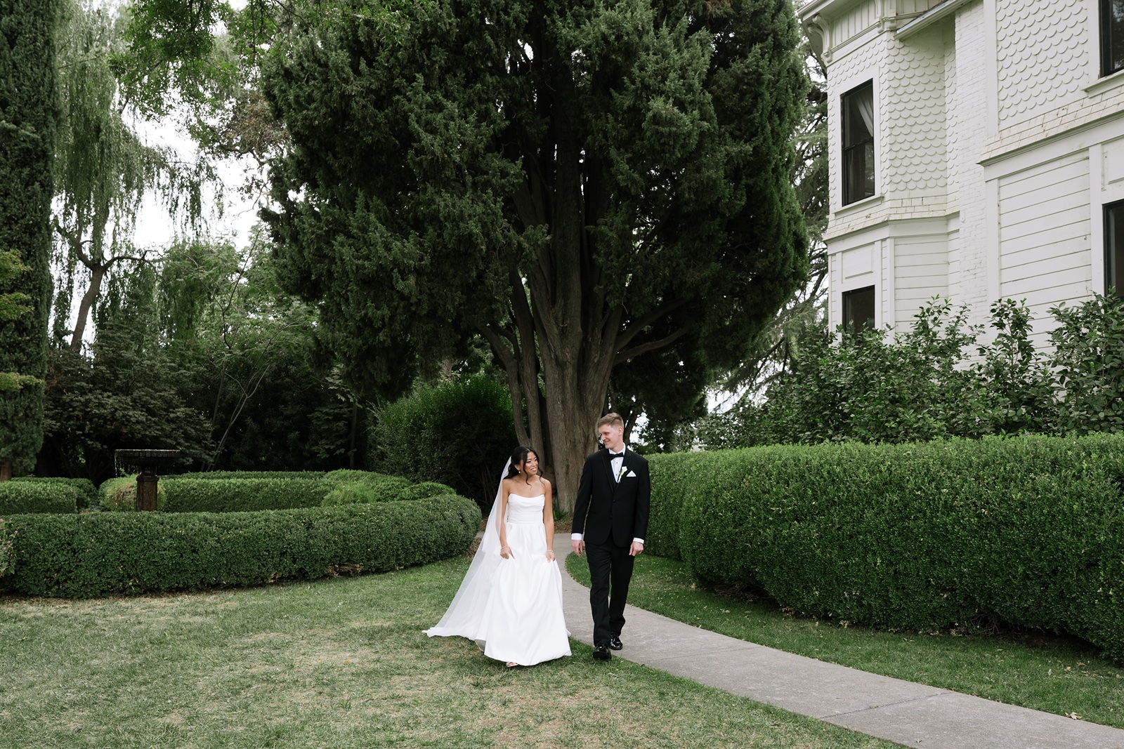 Bride and groom walk holding hands at their destination wedding in Northern California