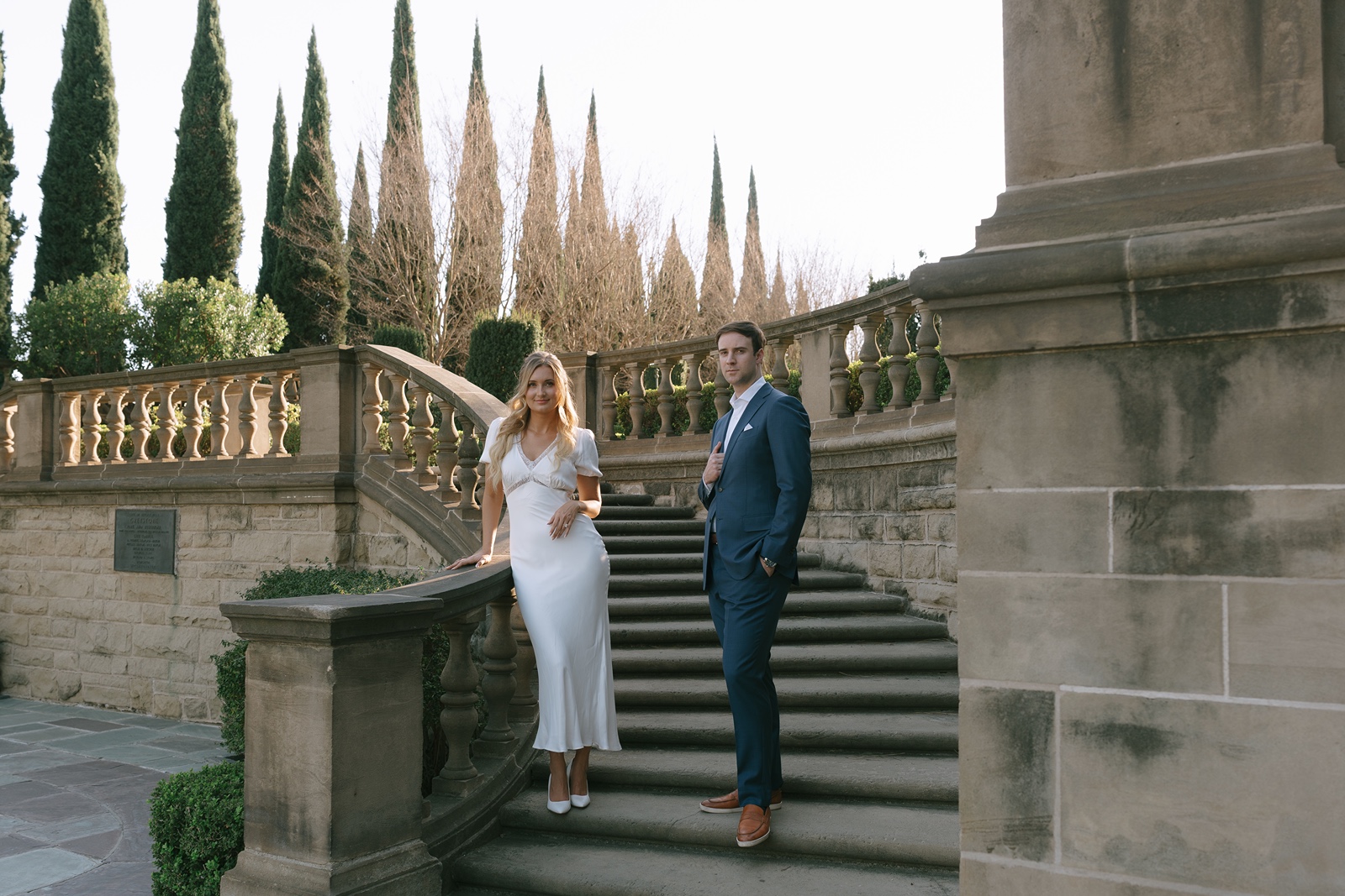 Man and woman on a staircase at their Los Angeles engagement photoshoot