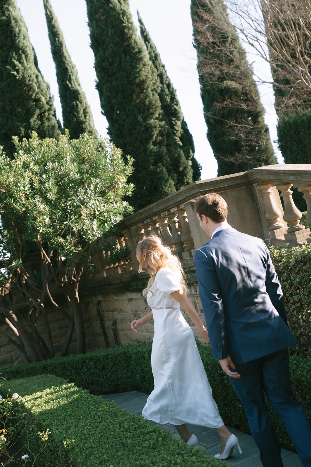 Couple holds hands during Los Angeles engagement photos at Greystone Mansion