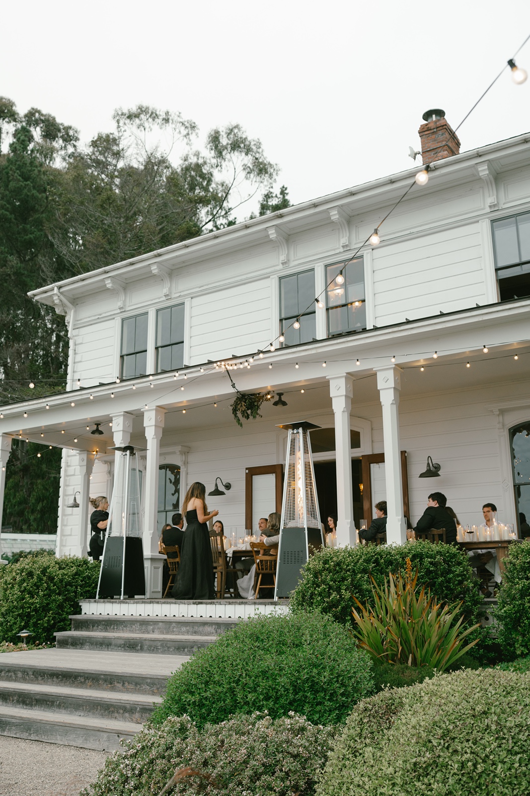 Guests enjoy dinner outdoors at the Switzer Farm wedding reception