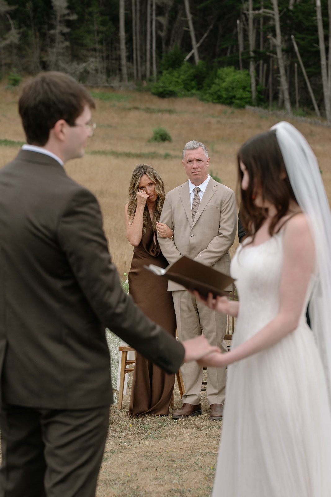 Bride and groom say vows at their outdoor Switzer Farm wedding ceremony