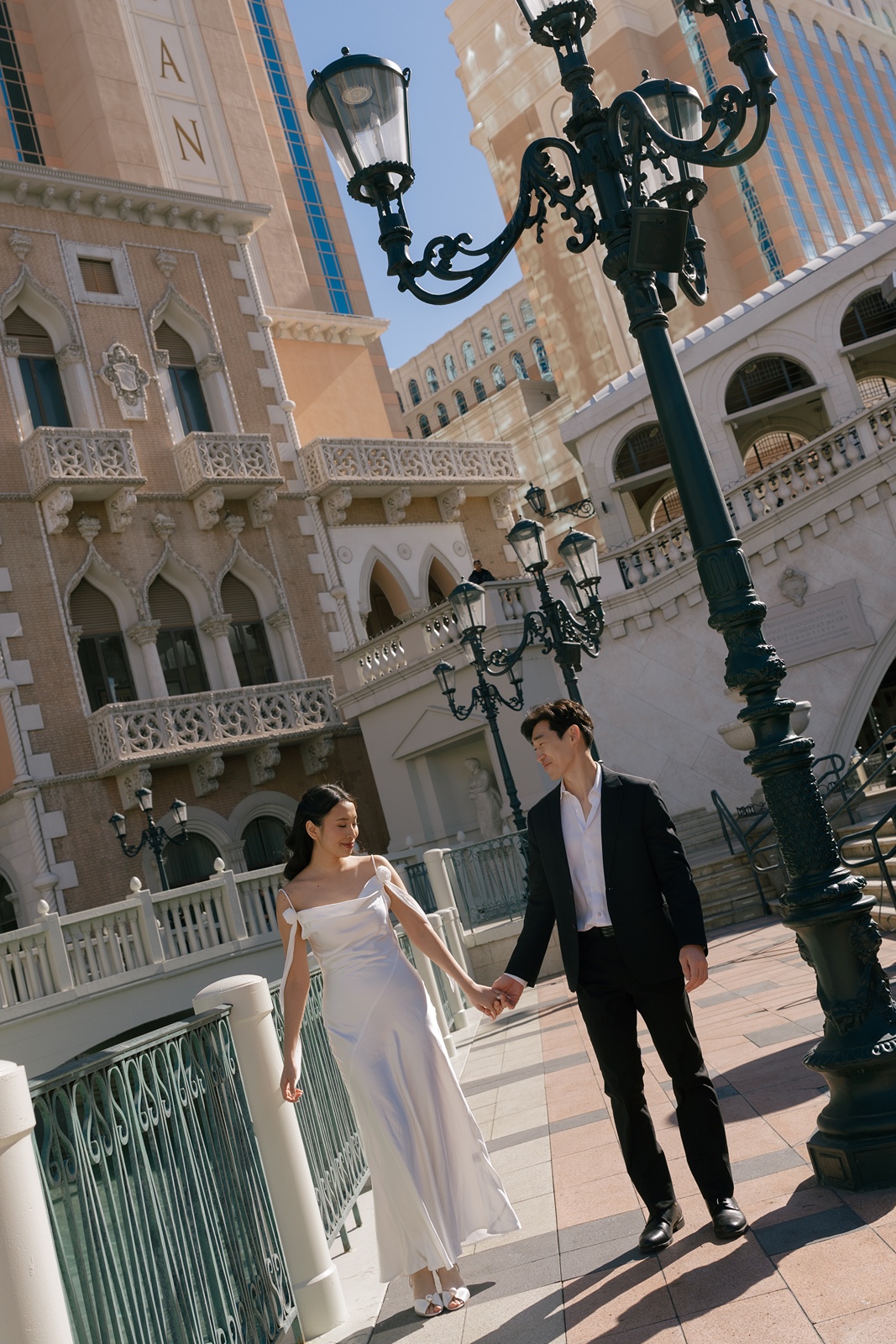 Couple holds hands during Las Vegas engagement photos