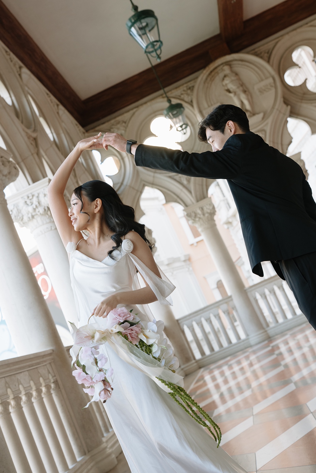 Man twirls woman at Las Vegas engagement photos