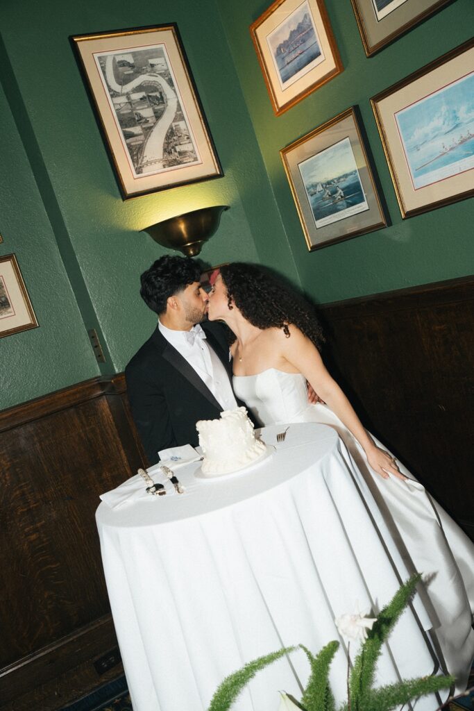 Bride and groom cut their wedding cake at their University Club of San Francisco wedding reception