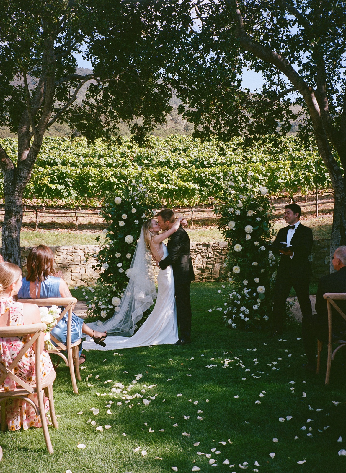 Bride and groom kiss during their Carmel Valley Ranch wedding ceremony